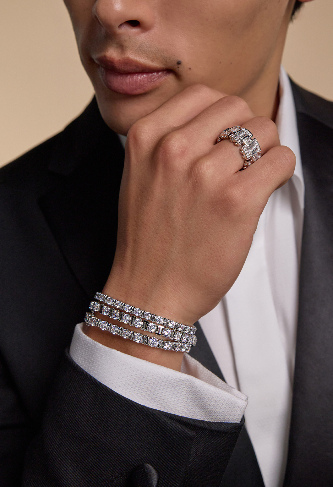 Three men's tennis bracelets displayed on the models hands with a fashion band on his right hand
